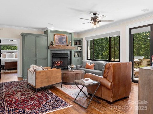 724 Moore Rd, Tryon, NC 28782 - living room featuring plenty of natural light, ornamental molding, wood finished floors, and a fireplace