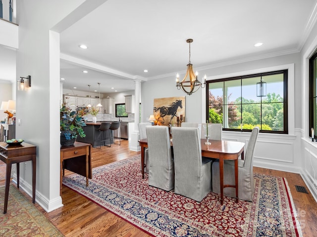724 Moore Rd, Tryon, NC 28782 - dining area featuring healthy amount of natural light, wood finished floors, a chandelier, recessed lighting, and crown molding