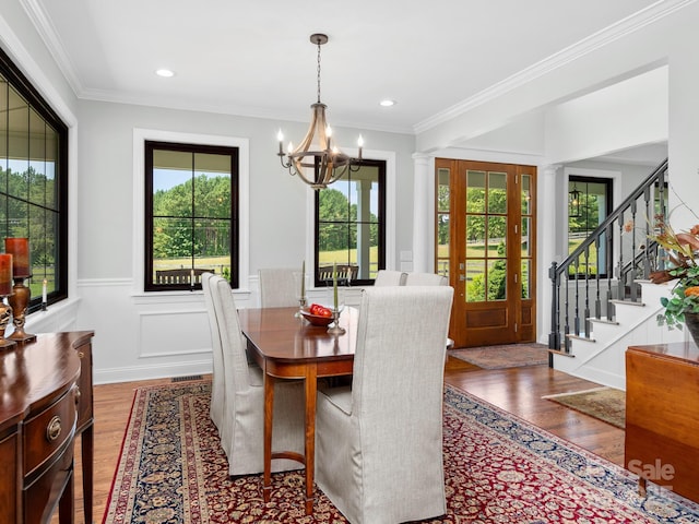 724 Moore Rd, Tryon, NC 28782 - dining space featuring a chandelier, plenty of natural light, wood finished floors, a wainscoted wall, and crown molding