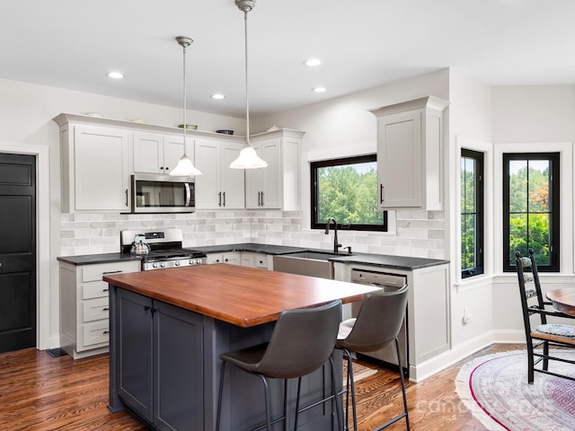 724 Moore Rd, Tryon, NC 28782 - kitchen featuring appliances with stainless steel finishes, wood counters, decorative backsplash, a center island, and recessed lighting
