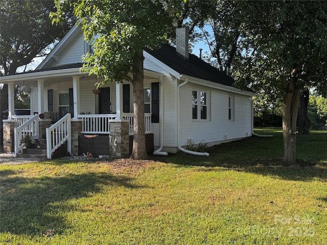 407 W Finger St, Maiden, NC 28650 - view of front of property with a chimney, a front yard, and covered porch