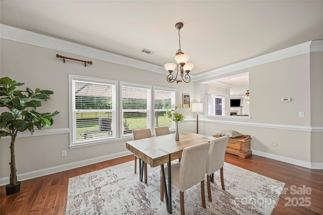 10420 Glenburn Ln, Charlotte, NC 28278 - dining area with a chandelier, wood finished floors, and crown molding