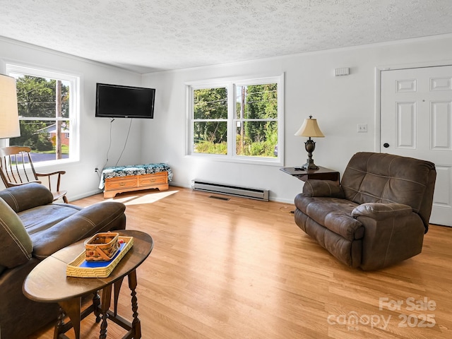 85 Pine Ridge Rd, Mars Hill, NC 28754 - living area featuring a textured ceiling, wood finished floors, a baseboard heating unit, and ornamental molding