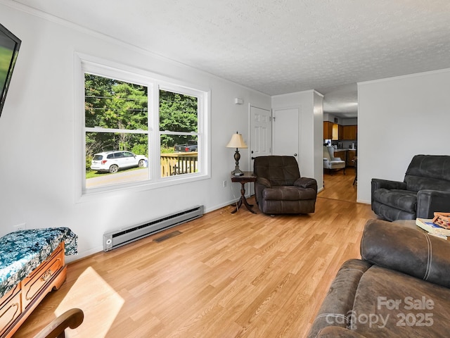 85 Pine Ridge Rd, Mars Hill, NC 28754 - living room featuring a baseboard radiator, wood finished floors, a textured ceiling, and ornamental molding