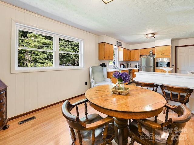 85 Pine Ridge Rd, Mars Hill, NC 28754 - dining area with light wood-type flooring, healthy amount of natural light, and a textured ceiling