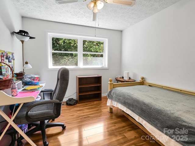 85 Pine Ridge Rd, Mars Hill, NC 28754 - bedroom with wood finished floors, an office area, and a textured ceiling