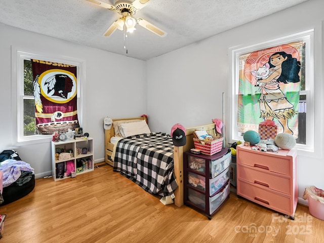 85 Pine Ridge Rd, Mars Hill, NC 28754 - bedroom with light wood-type flooring, a textured ceiling, and a ceiling fan