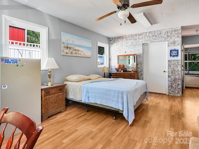 85 Pine Ridge Rd, Mars Hill, NC 28754 - bedroom with brick wall, light wood-style flooring, multiple windows, and a ceiling fan