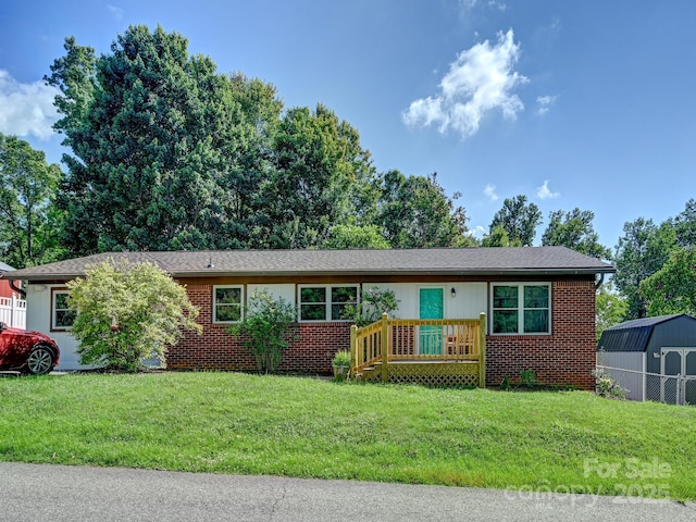 85 Pine Ridge Rd, Mars Hill, NC 28754 - ranch-style house with a front lawn, a storage unit, and brick siding