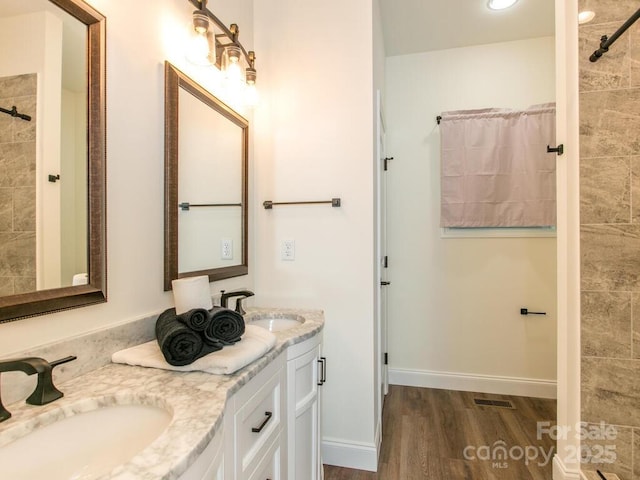 508 S Oconeechee Ave Unit 1, Black Mountain, NC 28711 - full bathroom with wood finished floors, double vanity, and a tile shower