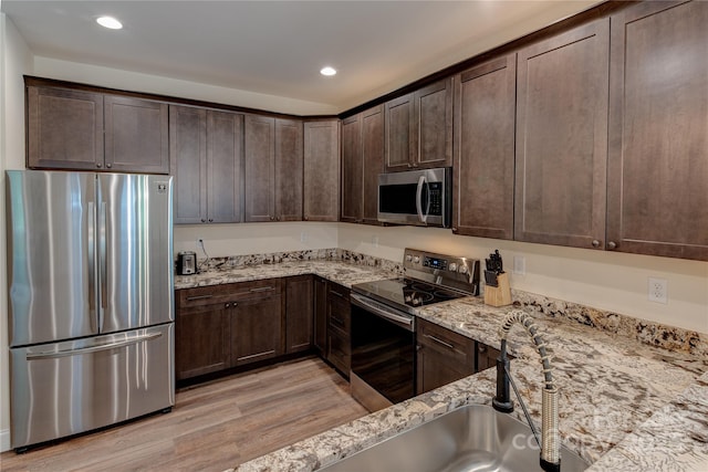 508 S Oconeechee Ave Unit 1, Black Mountain, NC 28711 - kitchen with stainless steel appliances, light wood-type flooring, dark brown cabinetry, and recessed lighting