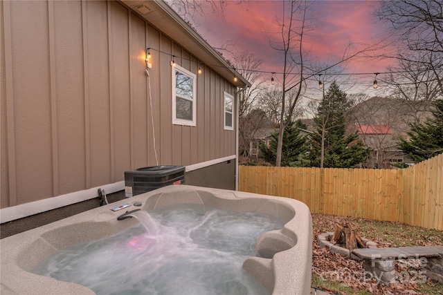 508 S Oconeechee Ave Unit 1, Black Mountain, NC 28711 - property exterior at dusk featuring an outdoor hot tub and board and batten siding