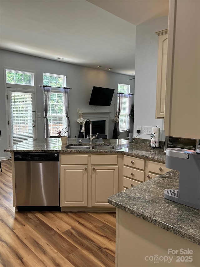 630 Springhouse Pl, Clover, SC 29710 - kitchen with a peninsula, stainless steel dishwasher, light wood-style floors, open floor plan, and a fireplace