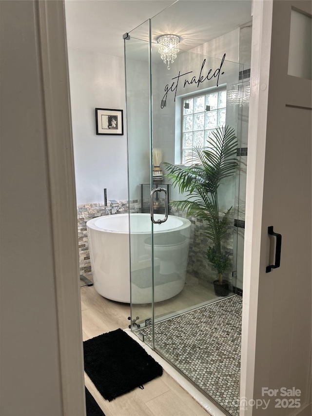630 Springhouse Pl, Clover, SC 29710 - bathroom featuring a freestanding bath, wood finished floors, and a shower stall