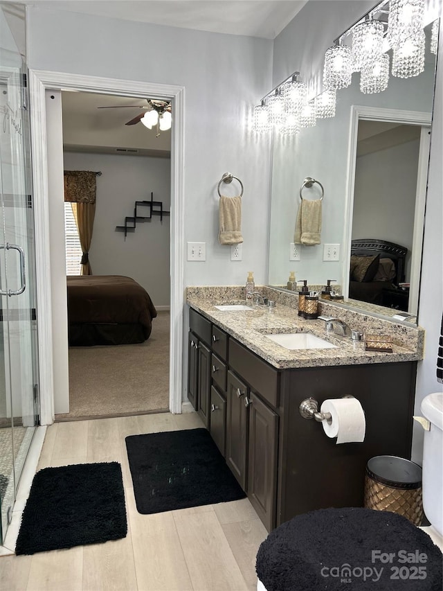 630 Springhouse Pl, Clover, SC 29710 - bathroom featuring ensuite bath, wood finished floors, double vanity, a stall shower, and a ceiling fan