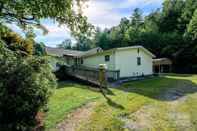 4720 Brevard Rd, Horse Shoe, NC 28742 - view of property exterior featuring a yard, a deck, driveway, and a carport