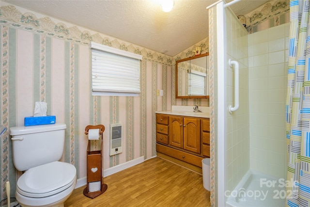 4720 Brevard Rd, Horse Shoe, NC 28742 - bathroom featuring heating unit, wood finished floors, a shower stall, vanity, and wallpapered walls