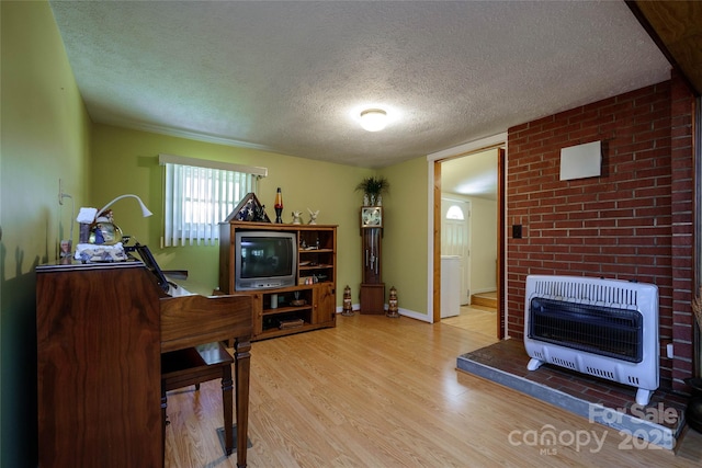 4720 Brevard Rd, Horse Shoe, NC 28742 - sitting room with heating unit, a textured ceiling, and wood finished floors