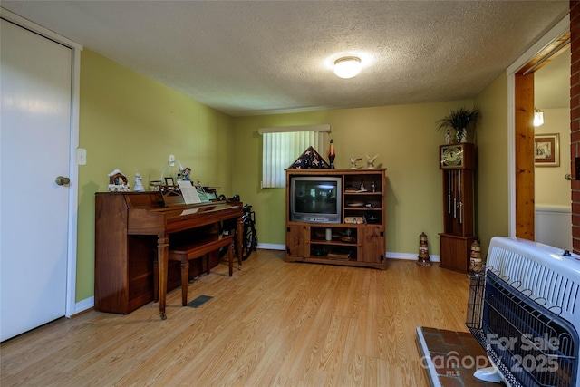 4720 Brevard Rd, Horse Shoe, NC 28742 - sitting room featuring a textured ceiling, wood finished floors, and heating unit