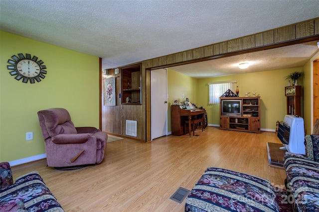 4720 Brevard Rd, Horse Shoe, NC 28742 - living room featuring a textured ceiling and wood finished floors