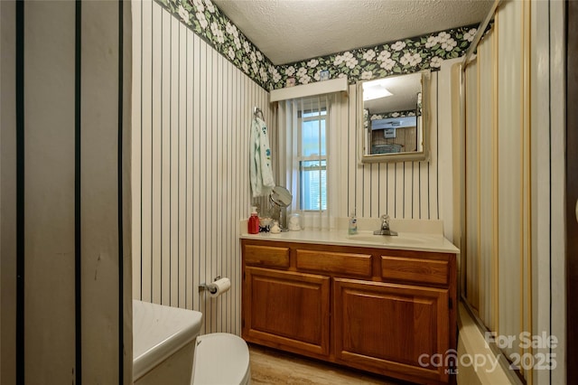 4720 Brevard Rd, Horse Shoe, NC 28742 - full bathroom featuring vanity, a textured ceiling, wallpapered walls, and shower / tub combo