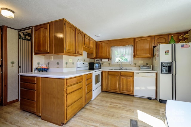 4720 Brevard Rd, Horse Shoe, NC 28742 - kitchen with white appliances, light wood-style flooring, brown cabinets, and light countertops