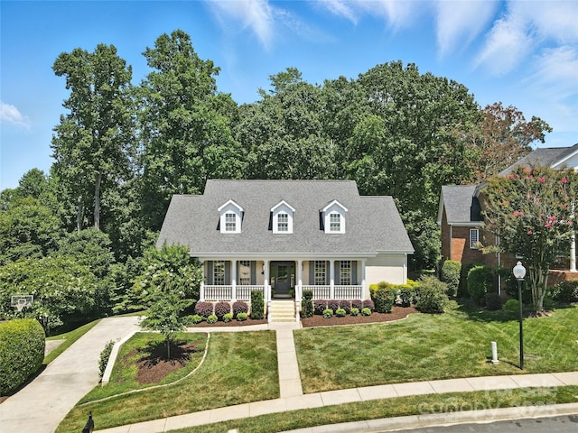9012 Arrington Manor Pl, Charlotte, NC 28277 - cape cod home featuring a porch, a front yard, and a shingled roof