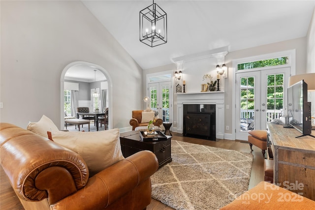 9012 Arrington Manor Pl, Charlotte, NC 28277 - living area featuring french doors, high vaulted ceiling, arched walkways, plenty of natural light, and wood finished floors
