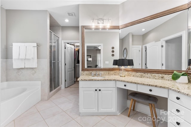 9012 Arrington Manor Pl, Charlotte, NC 28277 - bathroom with a bath, vanity, a shower stall, tile patterned flooring, and a spacious closet