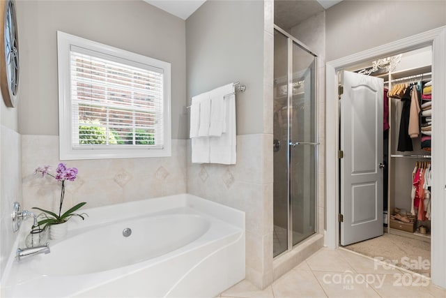 9012 Arrington Manor Pl, Charlotte, NC 28277 - bathroom with a bath, a shower stall, tile patterned flooring, a walk in closet, and wainscoting