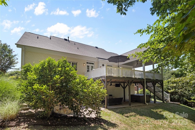 9012 Arrington Manor Pl, Charlotte, NC 28277 - back of property featuring a hot tub, a patio area, a deck, brick siding, and a yard