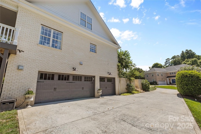 9012 Arrington Manor Pl, Charlotte, NC 28277 - view of side of home with an attached garage, driveway, and brick siding