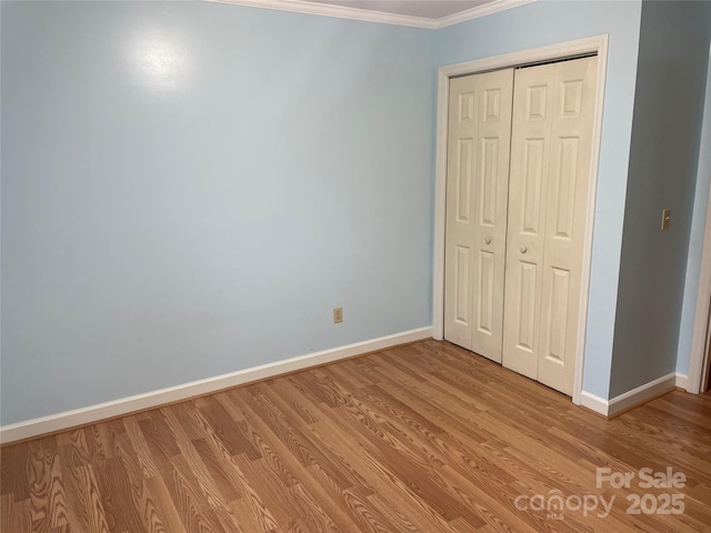 470 Roger Dr, Salisbury, NC 28147 - unfurnished bedroom featuring ornamental molding, light wood finished floors, and a closet