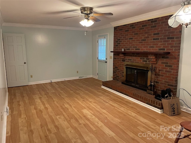 470 Roger Dr, Salisbury, NC 28147 - unfurnished living room featuring a ceiling fan, a brick fireplace, light wood-style floors, and crown molding