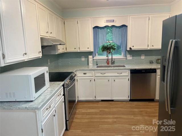 470 Roger Dr, Salisbury, NC 28147 - kitchen with stainless steel appliances, under cabinet range hood, light wood-type flooring, crown molding, and backsplash