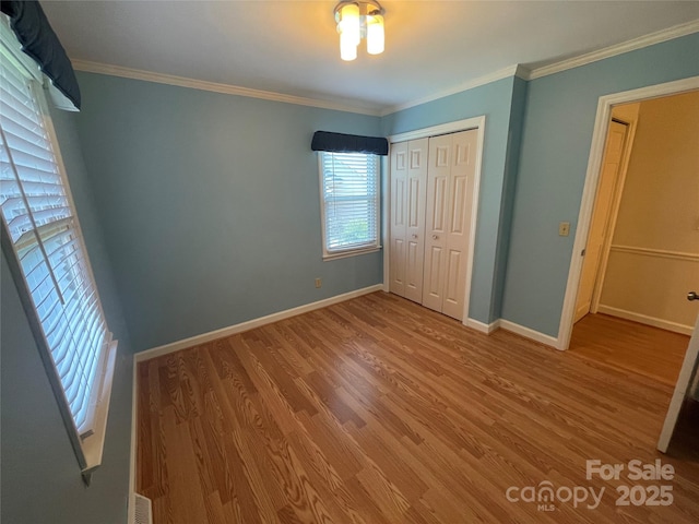 470 Roger Dr, Salisbury, NC 28147 - unfurnished bedroom featuring wood finished floors, a closet, and crown molding