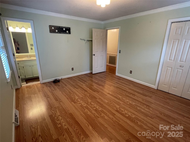 470 Roger Dr, Salisbury, NC 28147 - unfurnished bedroom featuring wood finished floors, crown molding, ensuite bath, and a closet