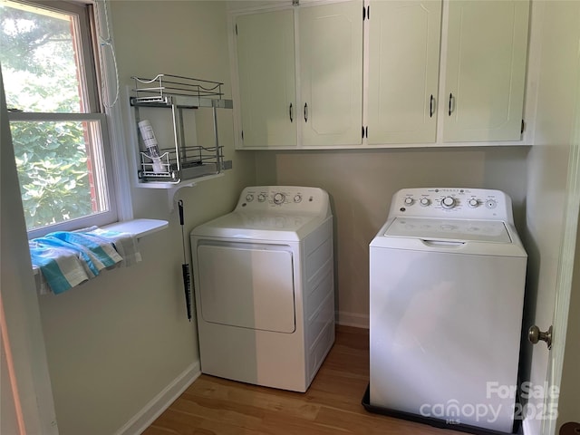 470 Roger Dr, Salisbury, NC 28147 - laundry room featuring washing machine and clothes dryer, cabinet space, and light wood finished floors