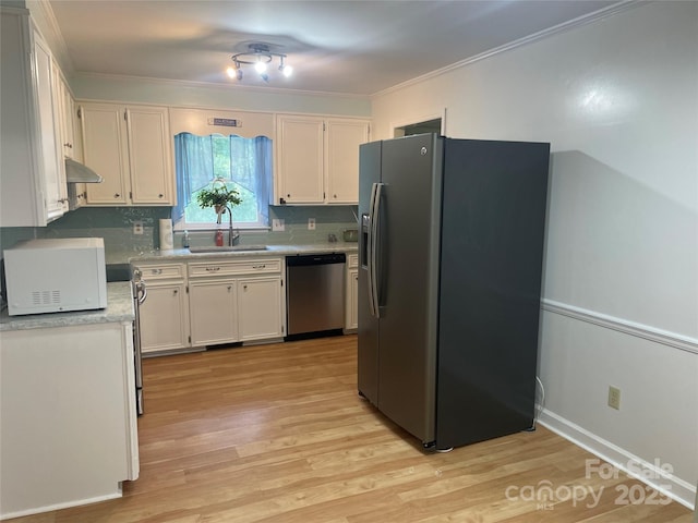 470 Roger Dr, Salisbury, NC 28147 - kitchen with appliances with stainless steel finishes, under cabinet range hood, light wood-style floors, light countertops, and white cabinets