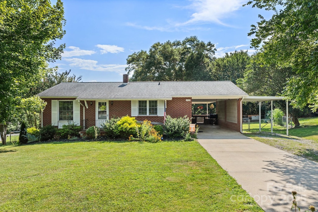 2348 Burke Memorial Park Rd, Valdese, NC 28690 - view of front of property with brick siding, a carport, a front yard, driveway, and a chimney