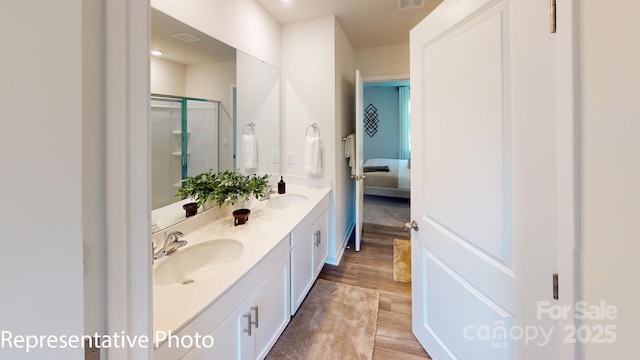 1053 20th Avenue Loop SE, Hickory, NC 28602 - ensuite bathroom with double vanity, wood finished floors, and a stall shower
