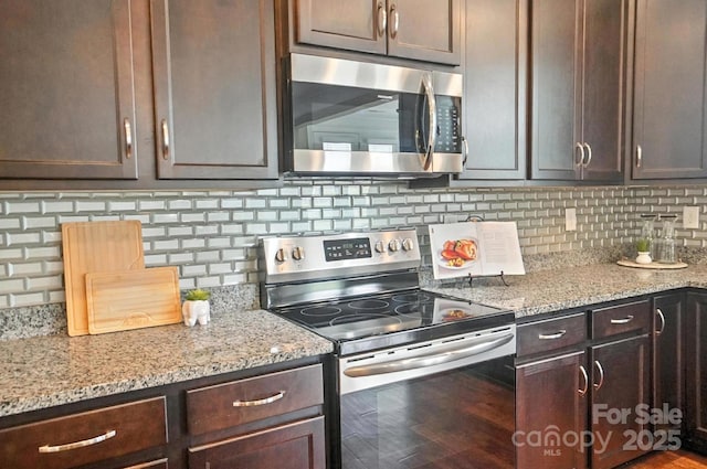 2006 Paddington Dr, Indian Trail, NC 28079 - kitchen with stainless steel appliances, dark brown cabinetry, and tasteful backsplash
