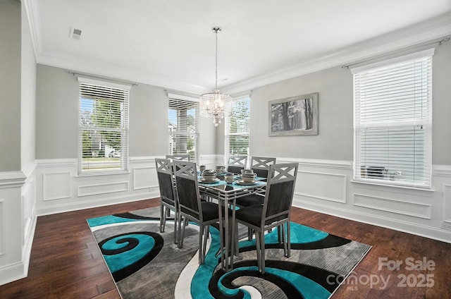 2006 Paddington Dr, Indian Trail, NC 28079 - dining room with wood finished floors, a chandelier, a wainscoted wall, and ornamental molding