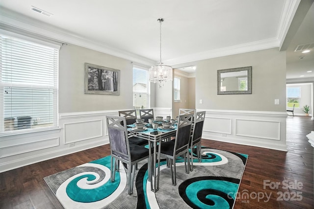 2006 Paddington Dr, Indian Trail, NC 28079 - dining room featuring a chandelier, crown molding, dark wood-style flooring, and wainscoting