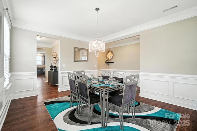 2006 Paddington Dr, Indian Trail, NC 28079 - dining room featuring a chandelier, dark wood-style floors, crown molding, a wainscoted wall, and a decorative wall
