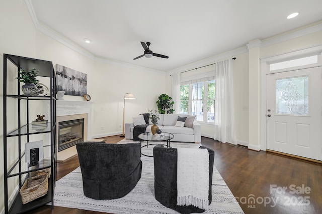 1855 Second Baxter Xing, Fort Mill, SC 29708 - living room featuring dark wood-style floors, a ceiling fan, a glass covered fireplace, crown molding, and recessed lighting