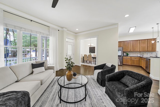 1855 Second Baxter Xing, Fort Mill, SC 29708 - living area featuring dark wood finished floors, a chandelier, ornamental molding, recessed lighting, and a ceiling fan