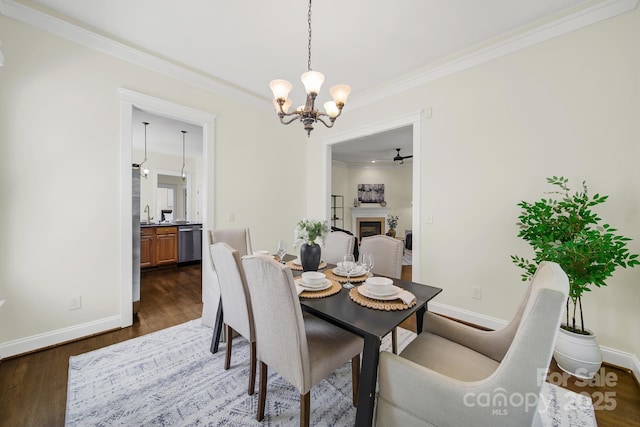 1855 Second Baxter Xing, Fort Mill, SC 29708 - dining room featuring ornamental molding, a chandelier, dark wood finished floors, and a fireplace