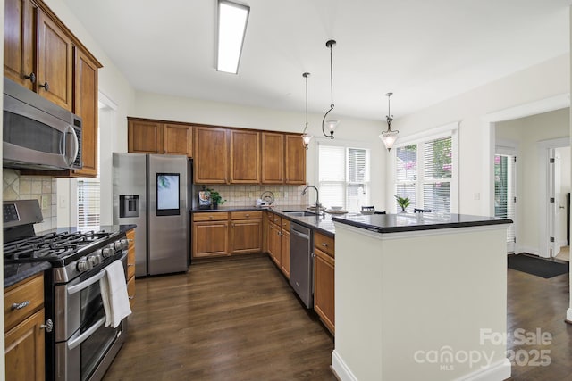 1855 Second Baxter Xing, Fort Mill, SC 29708 - kitchen with appliances with stainless steel finishes, dark countertops, dark wood-type flooring, tasteful backsplash, and brown cabinetry