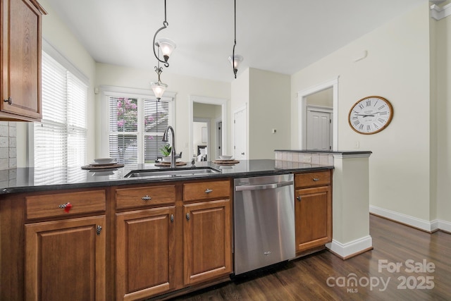 1855 Second Baxter Xing, Fort Mill, SC 29708 - kitchen featuring stainless steel dishwasher, brown cabinetry, dark wood finished floors, dark stone countertops, and decorative light fixtures